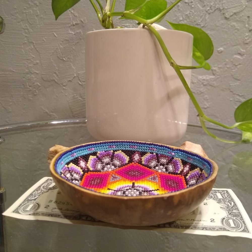 This is a wooden bowl with beads